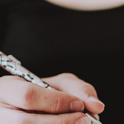 author writing in notebook with coffee